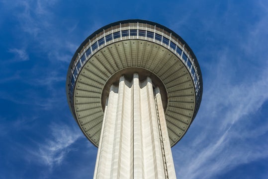 Looking up at the iconic landmark against Texas skies.