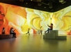 A number of visitors enjoying their time witnessing the beautiful floor to ceiling yellow florals displays at lluminarium Las Vegas