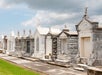 An outdoor scene featuring different tombstones with unique structure under a cloudy sky during the Cities of the Dead Cemetery History Tour by Haunted History Tours.