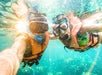 Two people wearing a snorkeling gears while snorkeling in Ft. Lauderdale/West Palm Beach while on Glass Bottom Boat and Snorkeling tour.
