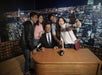 Four tourists capturing a moment by taking a picture of the Jimmy Fallon wax figure at Madame Tussauds.