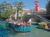 A group of tourists enjoying the Go Rio San Antonio River Cruise ride with Go San Antonio Explorer Pass.
