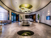 Beautifully decorated common area with a sofa and a luxurious chandelier.