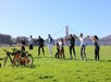 Group holding hands in front of the golden gate bridge