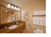 Private bathroom with sink. mirror, and toilet.