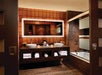 Private bathroom with sink. mirror, and toilet.