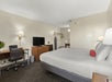 One king bed, desk and chair, flat screen TV inside a King Room.