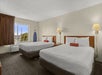 Two queen beds inside a non-smoking guest room.