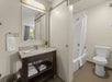 Guest bathroom with fresh towels and complimentary toiletries and a tub/shower combination.