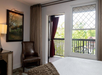 A bed, soft seating and a private balcony