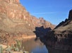 View of the famous rock formations of Grand Canyon with a shadow being cast across part of them on a sunny day.