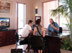Concierge desk staff chatting with two guests.