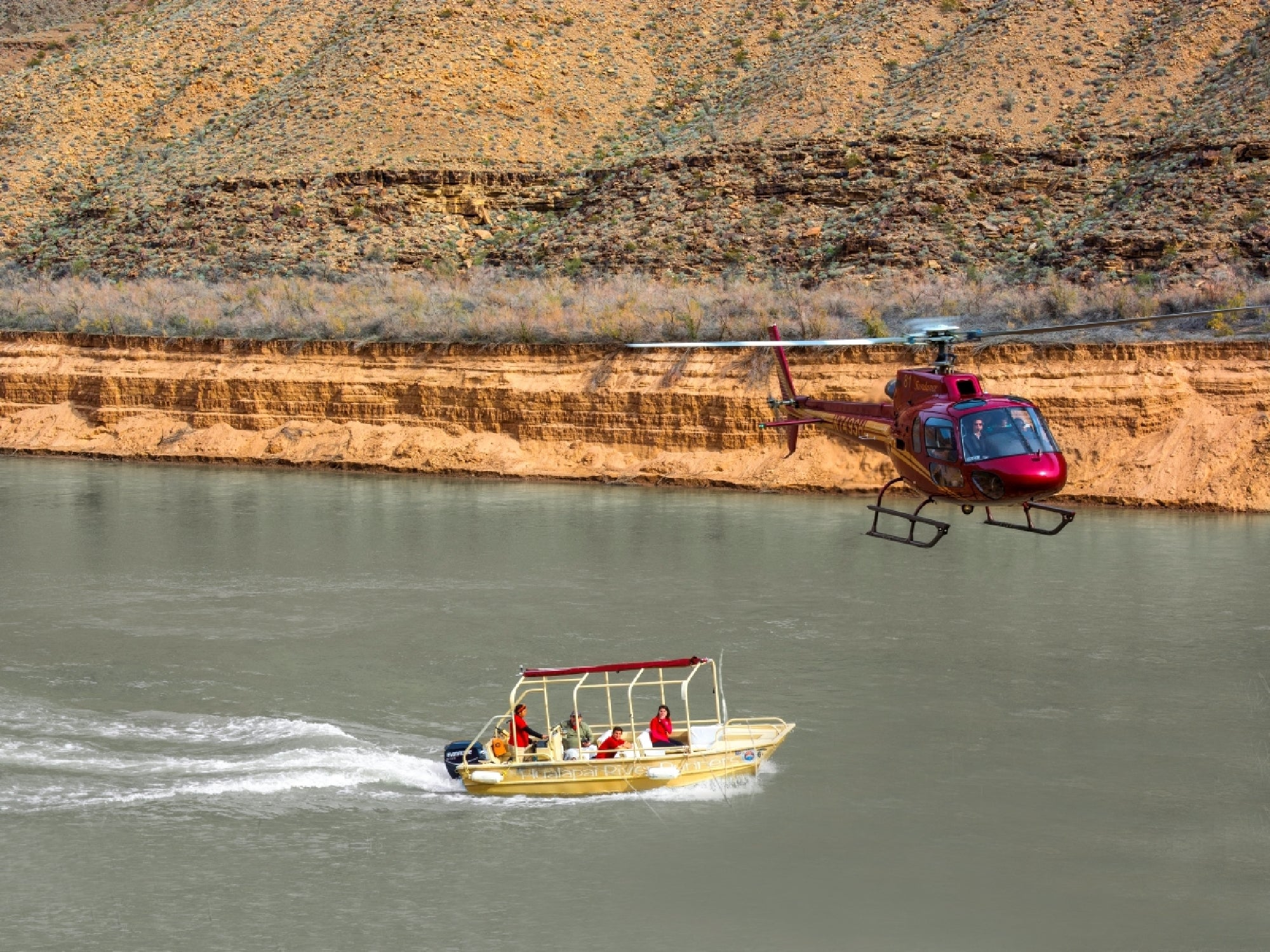 Helicopter soaring above Hualapai river boat.