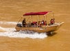 Hualapai river boat gliding through canyon waters.