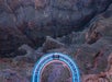 A curved glass skywalk extends over a deep canyon, with people standing on it and rugged rock walls below.