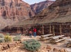 Guest photographing rugged canyon walls from the viewpoint.
