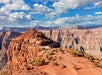 A rocky landscape with a canyon and blue sky.