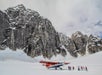 Group of people standing outside of the plane on the glacier landing in Talkeetna, Alaska.
