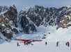 Group of people standing outside of the plane on the glacier landing in Talkeetna, Alaska.