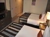 Guest room with two queen beds, microwave, and a flat-screen TV.