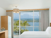 Guest room with ocean view and king bed.