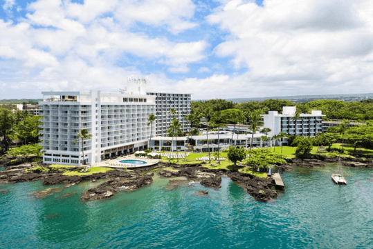 Beautiful landscaped oceanfront hotel exterior.