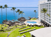 Beautiful landscaped oceanfront hotel exterior.