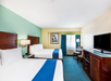Guest room with two queen beds and flat-screen TV.