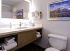 A well-lit vanity area with fresh towels and toiletries.