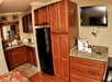 Flat-screen TV, refrigerator and microwave inside guest room at Gulfcoast Inn Naples, FL.