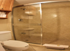 Glass enclosed shower inside a private bathroom at Gulfcoast Inn Naples, FL.