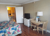 Guest room with 1 king bed, flat-screen TV and desk at Gulfcoast Inn Naples, FL.