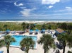 Aerial view of the outdoor pool and pool bar, and the walk way to the beach at Guy Harvey Resort in St. Augustine, FL.
