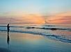 Guest fishing on the beach at sunrise.