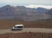 The tour van as it passes by the crater on the Haleakala Sunrise Tour in Wailuku Hawaii, USA.