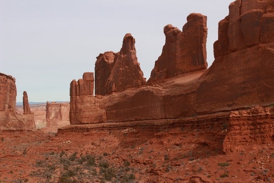 A wide shot the rock formations of the Red Rock Desert on an overcast day.