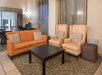 Comfortable and inviting lobby lounge with ample seating for relaxation or socializing.