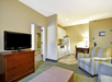 Separate living area, kitchen, and a flat-screen TV