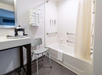 Accessible bath with tub and grab bars for safety and ease