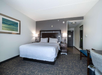 One king bed with carpeted floors for a cozy and restful stay
