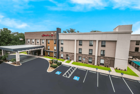 Hotel exterior and outdoor parking spaces.