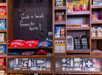 Store display with snacks, Cardinals merchandise, and personal care items. A sign reads "Grab a local favorite here!.