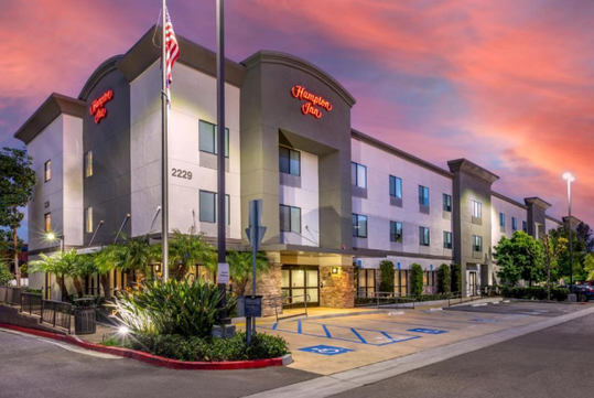 Hotel exterior at dusk.