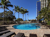 Outdoor pool with sun loungers.