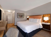The room offers a plush king bed for a peaceful night’s sleep.
