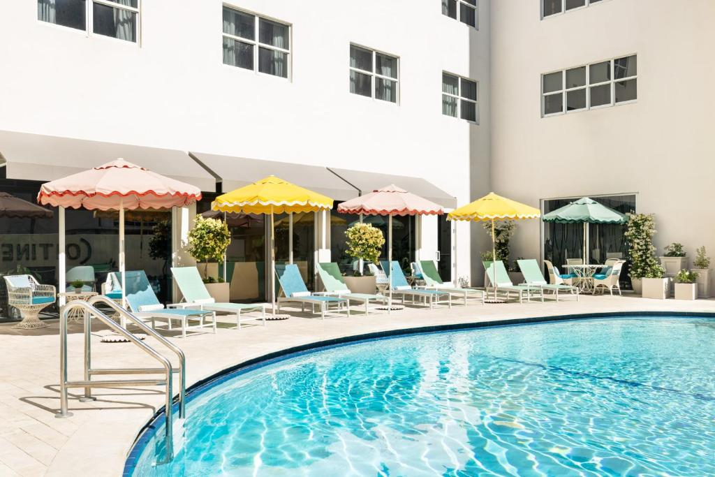Outdoor pool with sun loungers.