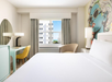 1 King bed, work area, and a comfortable seating inside a guest room.