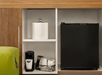 A shelf with a black mini-fridge, coffee maker, and ice bucket in a hotel room at the Hampton Inn Portland Airport.
