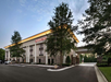 Hotel exterior surrounded with trees.