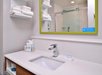 Private bathroom with vanity area and fresh towels.